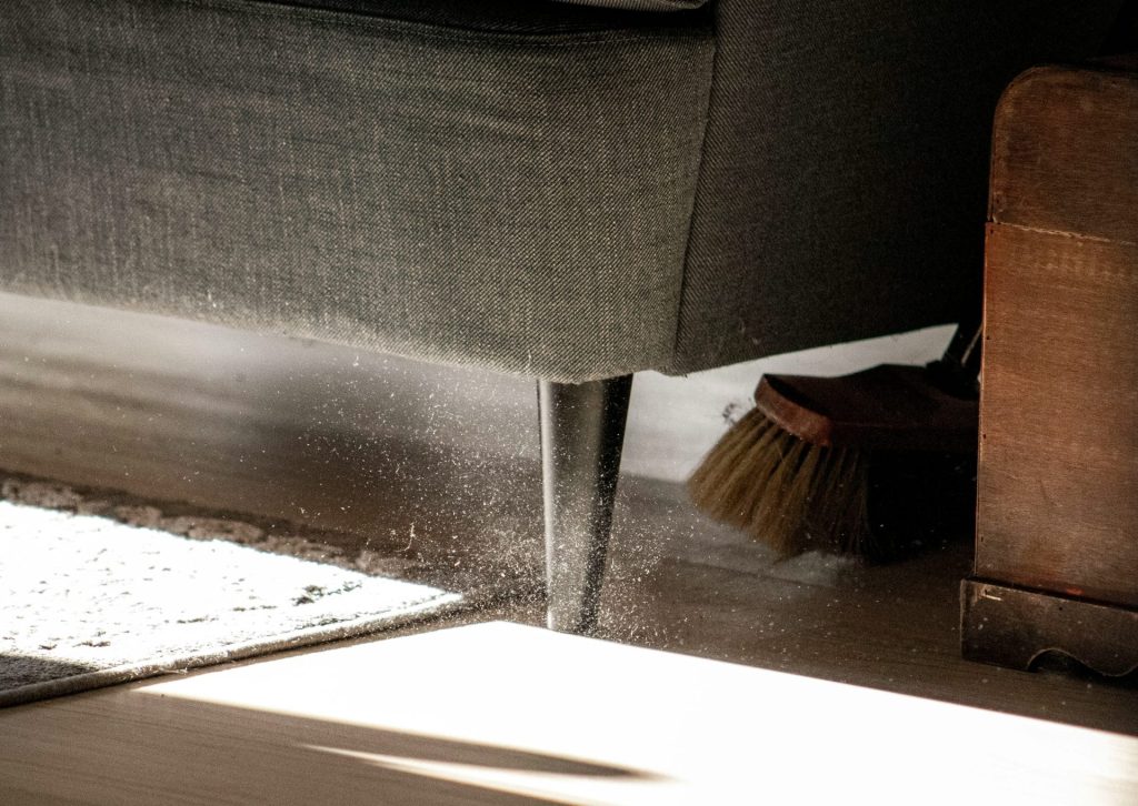 a close up of a chair with a broom on the floor
